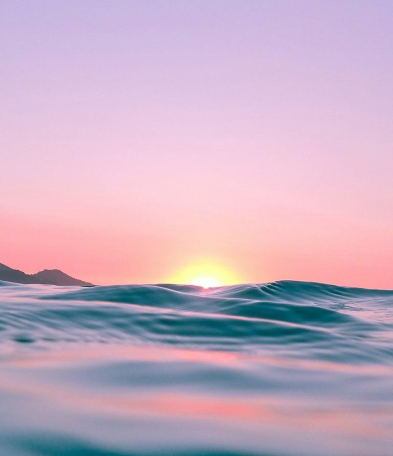 Image of the ocean with a sunset behind